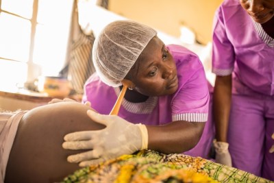 Student midwife checking foetus (file photo).